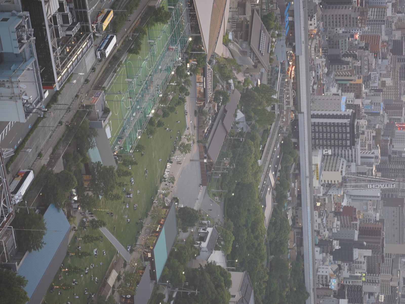A green plaza and dense city blocks viewed from above.